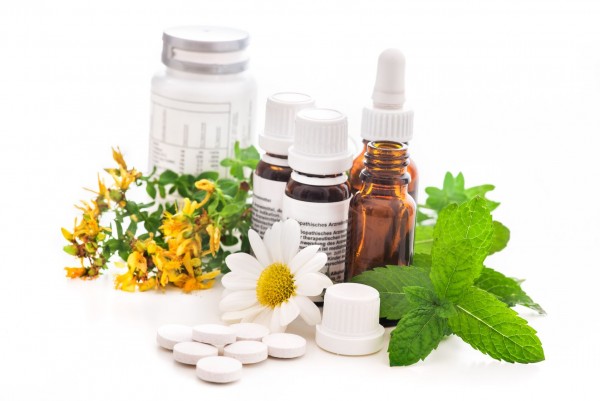 An image of natural supplements and dropper bottles to discuss what holistic treatments are.