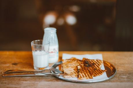 An image of milk and grilled cheese to represent unhealthy foods.