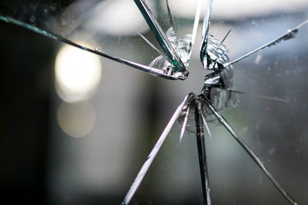 An image of cracked glass to represent how society has some flawed views on wellness and heathcare, and there are some major healthcare problems..