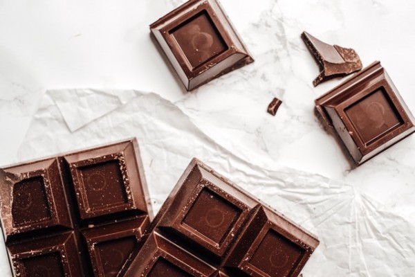 An image of some dark chocolate pieces to discuss how chocolate can help with mental health by relieving stress.