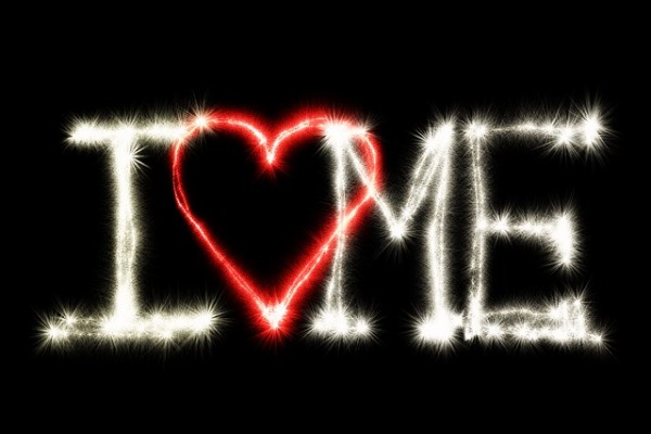 An image of the words "I love me" in sparkling lights to discuss how to go about loving yourself.