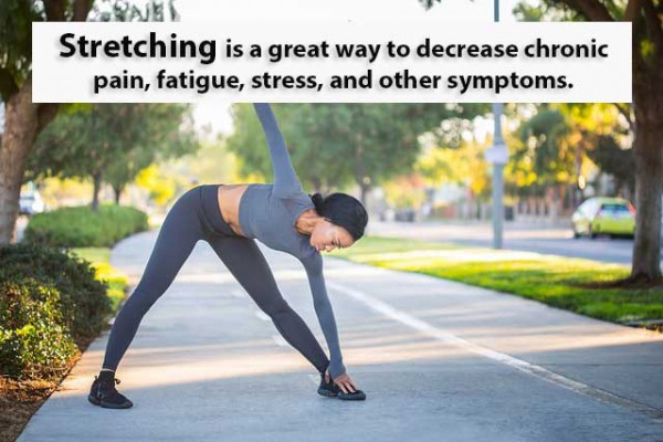 An image of a woman stretching to discuss the benefits of functional stretching for chronic pain.