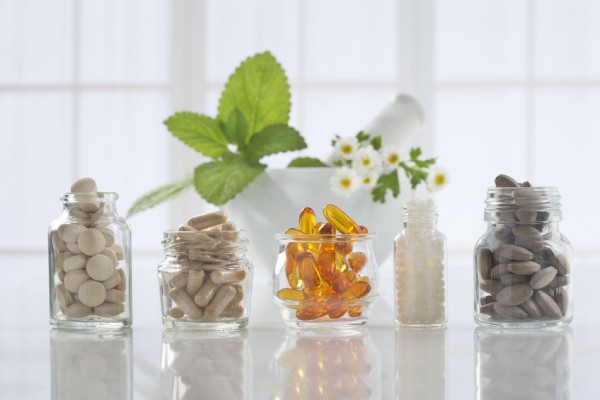 Several different supplements are in unlabeled glass jars 
